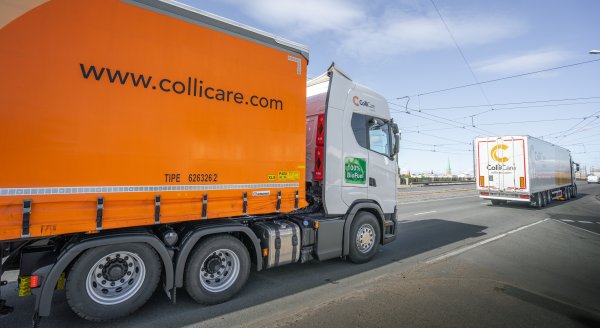 Two ColliCare trucks driving on a highway, en route to their destination.