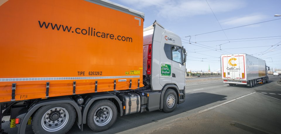 Two ColliCare trucks driving on a highway, en route to their destination.