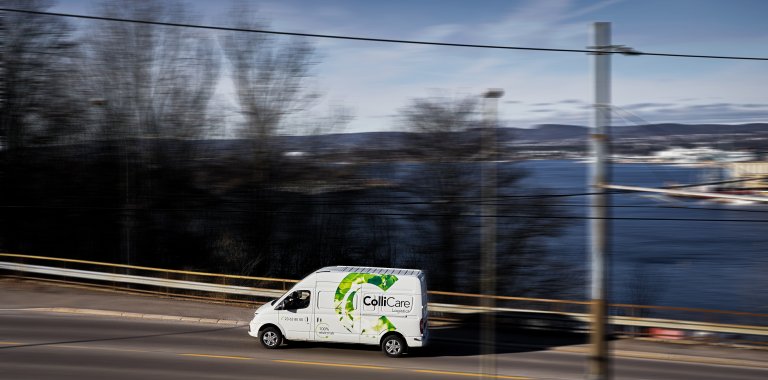 Electrical ColliCare van driving through the Northern Europe scenery for express delivery.